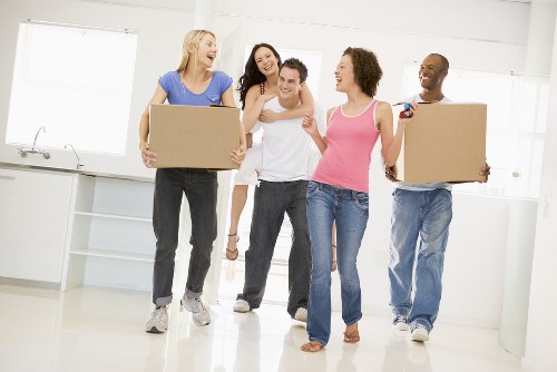 Furniture pick-up service handling a sofa in Acton