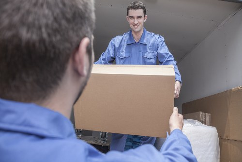 Professional movers packing household items in Acton