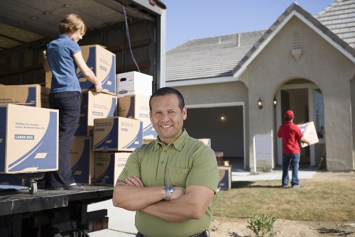 Packed boxes and furniture ready for an Acton relocation