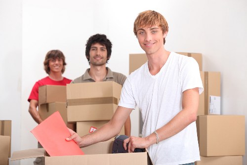 Professional movers loading items in Acton